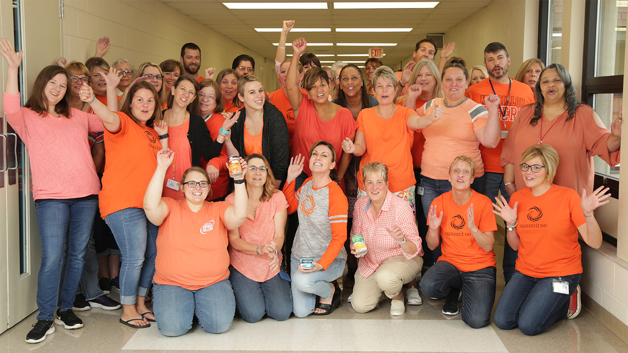 Hunger Summit DD Group Photo wearing orange t-shirts