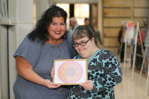 SSA Dayna and female artists showing off artwork