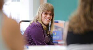 Summit DD staff, Jessica smiling during a training session