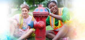 Two teens, Noah and Zaria, painting fire hydrants in Stow for the 2022 Summer Youth Work Program.