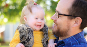 Katie with her father. Katie receives Summit DD Early Intervention services.