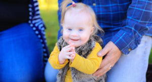 Katie sitting in a park. Katie receives Summit DD Early Intervention services.
