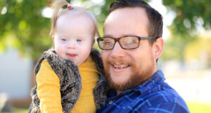 Katie with her father. Katie receives Summit DD Early Intervention services.