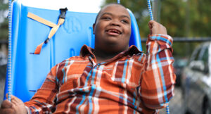 Travis on a swing at his Total Education Solutions School.