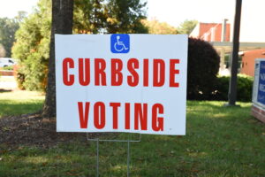 "Curbside Voting" sign with accessibility symbol