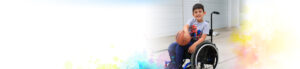 Young boy in wheelchair playing basketball.