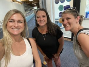 Sarah Tedrick (of World Elite Kids) smiling with Jacquie Owens and Brooke Wisniewski (of Summit DD)