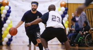 Special Olympics athletes playing a basketball game against Summit DD staff.