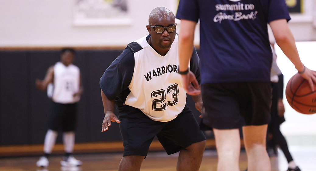 Special Olympics athletes playing a basketball game against Summit DD staff.