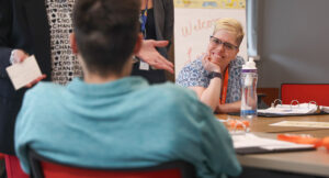 Jessica, a program participant, smiling while working on a project.