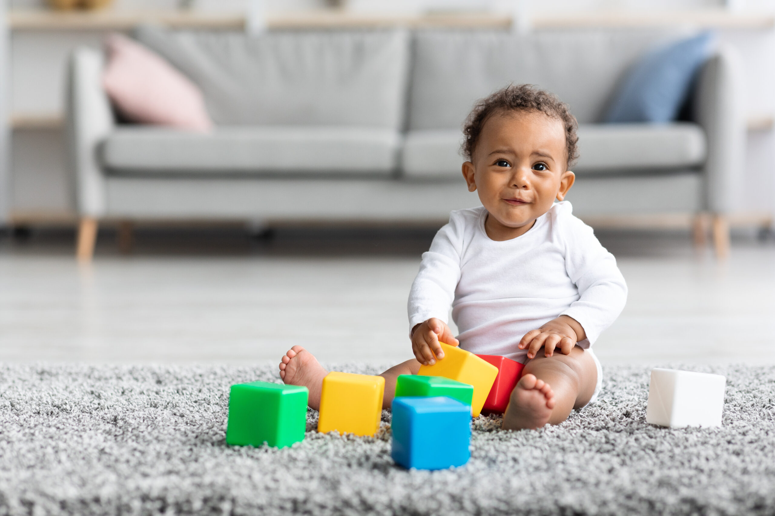 Development Games For Babies. Cute African-American Infant Child Playing With Building Blocks