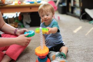 Toddler stacking colorful rings on a toy