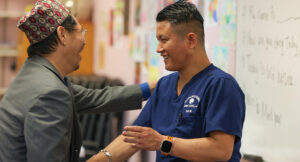 Yam teaching sign language at Intra-National Homecare.