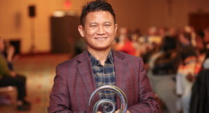 Yam receiving his Carlene Weaver Achievement Award at the Summit DD Awards Breakfast.