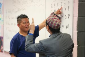 Yam M. teaching sign language at Intra-National Homecare.