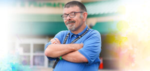 Portrait of an Acme employee, Scott, standing in from our the Acme entrance sign.