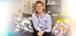 Photo of Evan sitting on the Smart Home couch smiling proudly.