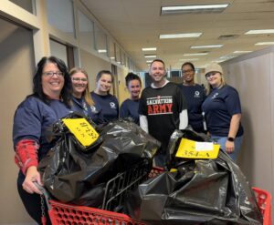 Group of people gathered together smiling.