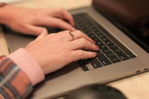 Woman's hands on laptop typing