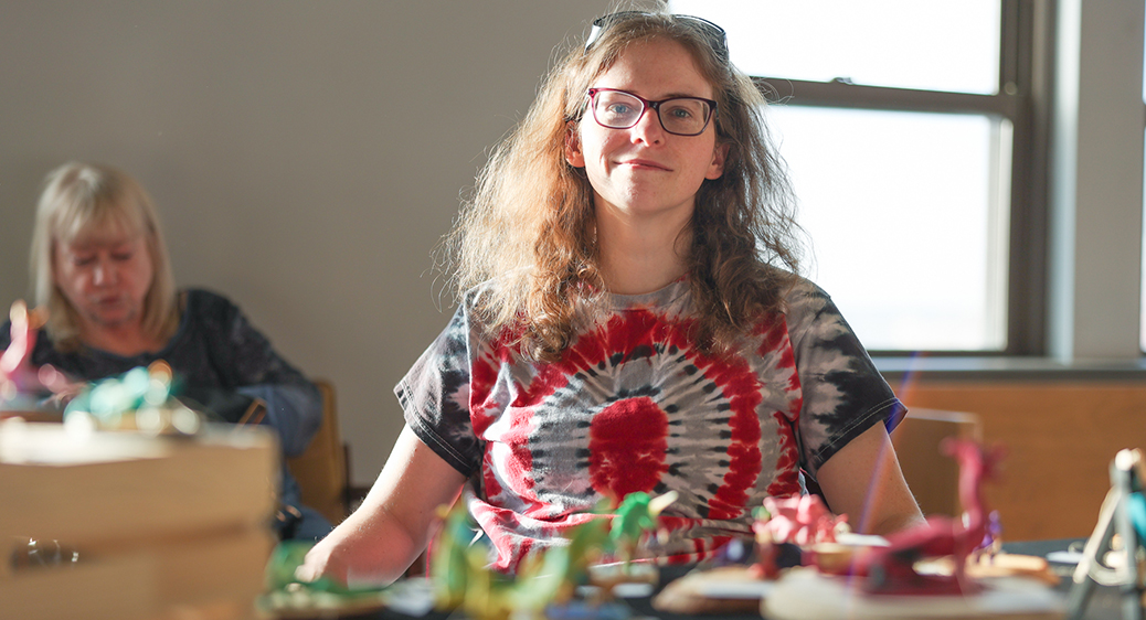Portrait of artist Elizabeth in front of her sculptures at the Summit Art Walk.