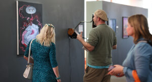 Photo of community members looking at artwork.