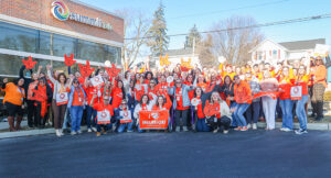 Large Summit DD employee group photo of everyone wearing orange on Inclusion Day.