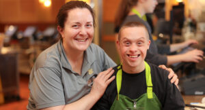 Portrait of award winner Katherine Koral with her arms around coworker Joe at Panera Bread in Hudson.