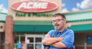 Portrait of Award Winner Scott Fox standing confidently in front of his workplace Acme.