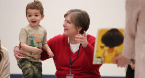 Summit DD Developmental Specialist playing with child during Music Therapy class.