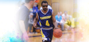 Basketball player dribbling ball across court at Summit DD Special Olympics Basketball Game.
