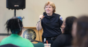 Akron Police Office Lauri Natko presenting in front of the an audience at the Home Visit Safety Training.