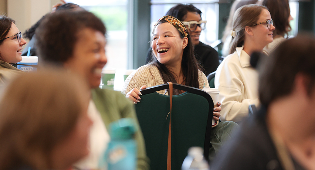 An audience member smiling at the Summit DD Home Visit Safety Training.