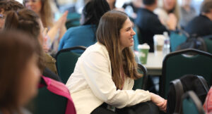 An audience member smiling at the Summit DD Home Visit Safety Training.