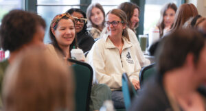 An audience member smiling at the Summit DD Home Visit Safety Training.