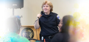 Akron Police Office Lauri Natko presenting in front of the an audience at the Home Visit Safety Training.