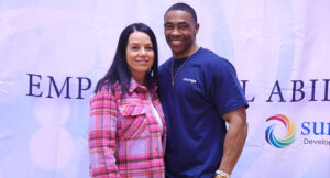 Community members posing for a group photo at the Special Olympics vs Summit DD game.
