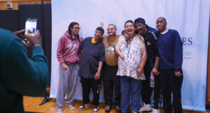 Community members posing for a group photo at the Special Olympics vs Summit DD game.