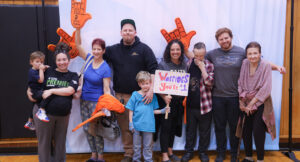 Community members posing for a group photo at the Special Olympics vs Summit DD game.