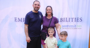 Community members posing for a group photo at the Special Olympics vs Summit DD game.