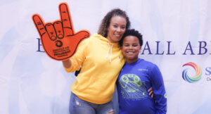 Community members posing for a group photo at the Special Olympics vs Summit DD game.