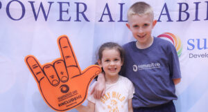 Community members posing for a group photo at the Special Olympics vs Summit DD game.