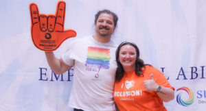 Community members posing for a group photo at the Special Olympics vs Summit DD game.
