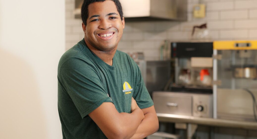 Smiling young man posing for a photo at his job with Cuyahoga Falls Parks and Recreation.