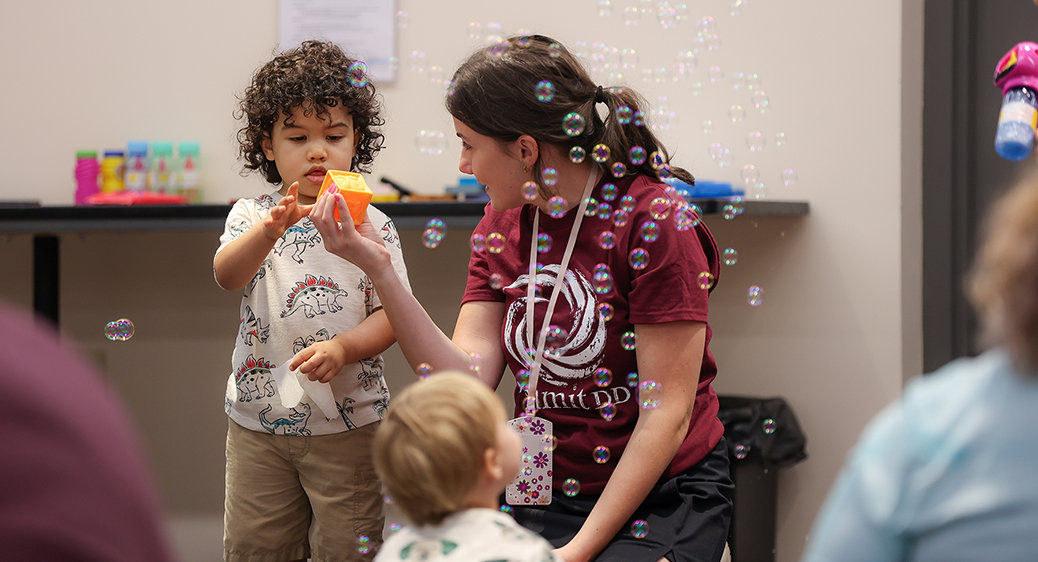 Summit DD team member playing with a child at the Speech Language Pathology Playgroup.