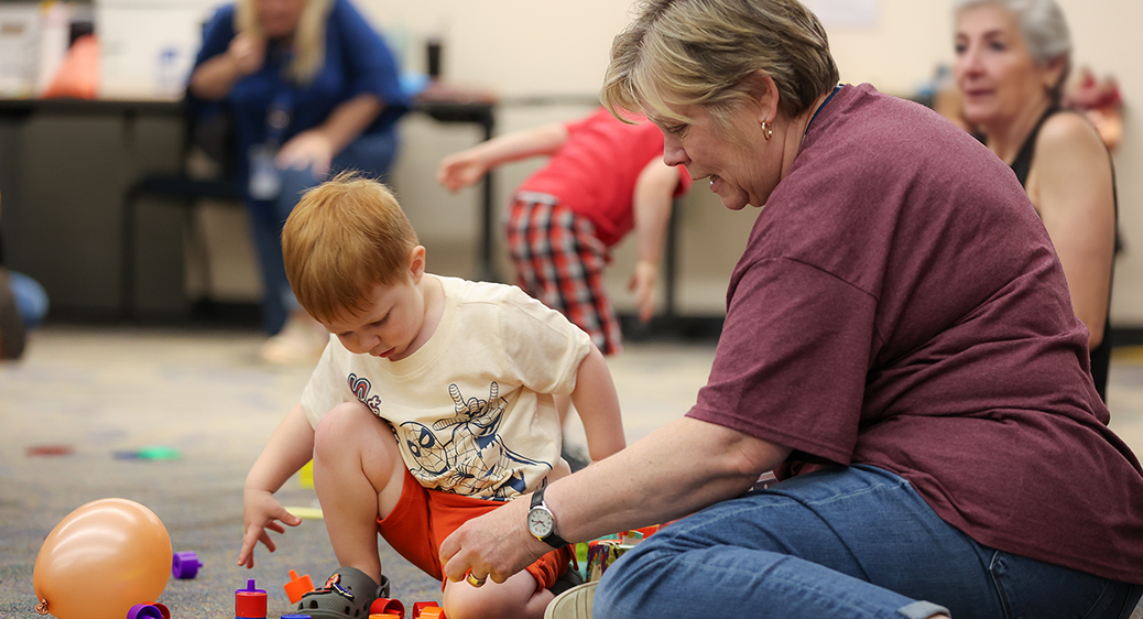 Summit DD team member playing with a child at the Speech Language Pathology Playgroup.