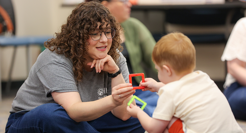 Summit DD team member playing with a child at the Speech Language Pathology Playgroup.