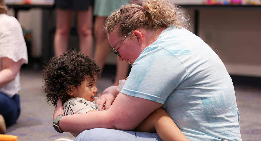 Summit DD team member playing with a child at the Speech Language Pathology Playgroup.