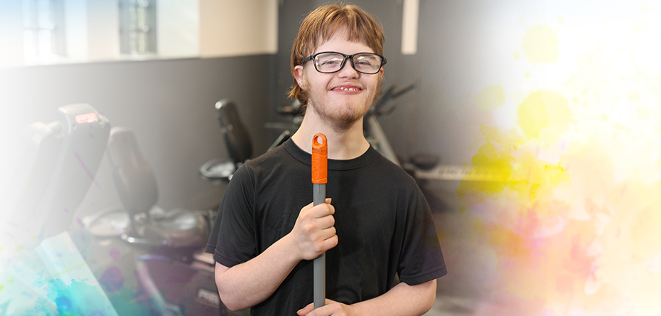 Smiling teen cleaning a local gym for the Summer Youth program.