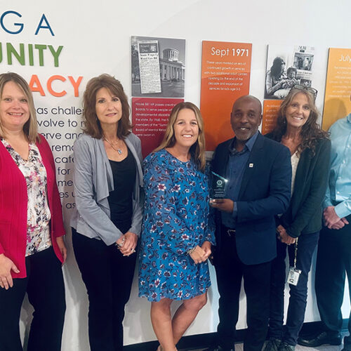 Summit DD executive leadership smiling in a group photo while receiving a community award from the United Way.