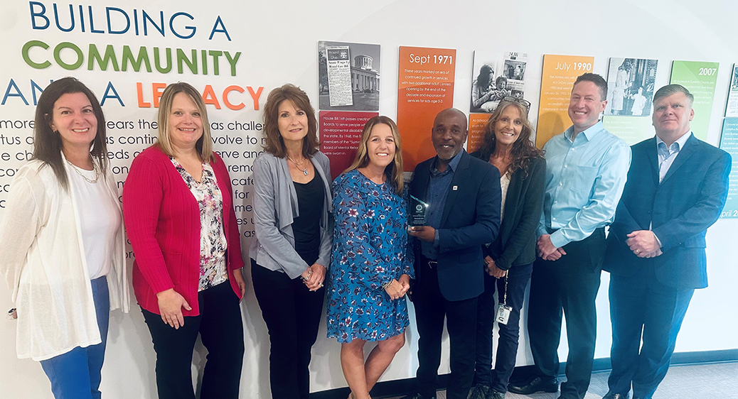Summit DD executive leadership smiling in a group photo while receiving a community award from the United Way.